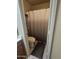 Small bathroom with a toilet and a shower behind a gray patterned shower curtain at 6036 W Mescal St, Glendale, AZ 85304