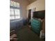 Bedroom with a desk, a chest of drawers, a TV, and a window for natural light at 6036 W Mescal St, Glendale, AZ 85304