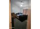 Bedroom featuring a bed, dresser, window with curtains, and gray carpeting at 6036 W Mescal St, Glendale, AZ 85304