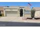 Charming single-story home with a two-car garage, landscaped front yard, and American flag at 6036 W Mescal St, Glendale, AZ 85304