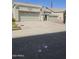 Front exterior of house, including a large driveway leading up to the two car garage at 6036 W Mescal St, Glendale, AZ 85304