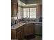 Bright kitchen featuring stainless steel appliances, a window view, tile floors, and a modern faucet at 6036 W Mescal St, Glendale, AZ 85304