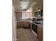 Kitchen with modern appliances, light wood cabinets, and tile flooring for easy cleaning at 6036 W Mescal St, Glendale, AZ 85304
