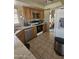 Kitchen with stainless steel appliances, granite countertops, and tile flooring at 6036 W Mescal St, Glendale, AZ 85304