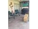 Comfortable covered patio with stylish seating, a fireplace, tile flooring, and outdoor decor at 6036 W Mescal St, Glendale, AZ 85304