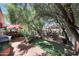 Spacious backyard featuring brick pavers, lush greenery, shade umbrellas, and mature trees at 7368 E Pleasant Run, Scottsdale, AZ 85258