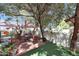 Backyard with brick pavers, a small putting green, shade umbrellas, and mature trees at 7368 E Pleasant Run, Scottsdale, AZ 85258