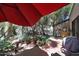 Backyard with brick pavers, putting green, mature trees, and a red shade umbrella at 7368 E Pleasant Run, Scottsdale, AZ 85258
