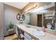Charming bathroom featuring dual sinks, a large mirror, and a walk-in shower at 7368 E Pleasant Run, Scottsdale, AZ 85258