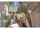 Picturesque courtyard with brick pavers, mature trees, and wrought iron gate at 7368 E Pleasant Run, Scottsdale, AZ 85258