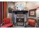 Close-up of a charming fireplace with decorative accents and adjacent seating at 7368 E Pleasant Run, Scottsdale, AZ 85258