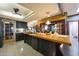 Bright and open kitchen with a ceiling fan, long breakfast bar, and access to other living spaces at 7368 E Pleasant Run, Scottsdale, AZ 85258