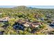 Gorgeous estate featuring a clay tile roof, lush landscaping, a resort style pool and desert and mountain views at 7552 E Whisper Rock Trl, Scottsdale, AZ 85266
