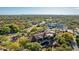 Upscale home featuring a clay tile roof, lush trees, outdoor entertaining space and beautiful desert landscape at 7552 E Whisper Rock Trl, Scottsdale, AZ 85266