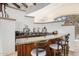 Modern bar area with granite countertops, custom cabinetry, and seating for three at 7552 E Whisper Rock Trl, Scottsdale, AZ 85266