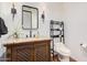 Chic powder room boasts a decorative vanity with granite countertop, stylish mirror, and sleek fixtures at 7552 E Whisper Rock Trl, Scottsdale, AZ 85266