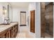 Bathroom featuring a double vanity and a shower with a glass door at 7552 E Whisper Rock Trl, Scottsdale, AZ 85266