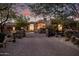 Gated driveway leading to the home with lush desert landscaping and stone accents at 7552 E Whisper Rock Trl, Scottsdale, AZ 85266