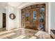 Grand entryway featuring double doors with windows, tile floors, and a mirror at 7552 E Whisper Rock Trl, Scottsdale, AZ 85266