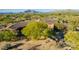 Majestic home from above, surrounded by vibrant greenery and desert landscapes at 7552 E Whisper Rock Trl, Scottsdale, AZ 85266
