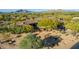 Elevated view of a sprawling residence with lush trees and manicured grounds at 7552 E Whisper Rock Trl, Scottsdale, AZ 85266