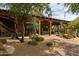 Inviting front porch featuring Southwestern architecture, desert landscaping and an airy and shaded entertaining space at 7552 E Whisper Rock Trl, Scottsdale, AZ 85266