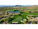 Scenic view of a golf course with manicured greens, mature trees, sand traps and a tranquil water feature at 7552 E Whisper Rock Trl, Scottsdale, AZ 85266