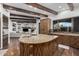 Open concept kitchen featuring a large island with a sink, custom cabinets, and an open concept to the living room at 7552 E Whisper Rock Trl, Scottsdale, AZ 85266