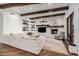 Bright and airy living room with beamed ceilings, a fireplace, and custom built-in shelves at 7552 E Whisper Rock Trl, Scottsdale, AZ 85266