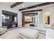Living room featuring beamed ceilings and an open concept to the kitchen with views of the outdoor area at 7552 E Whisper Rock Trl, Scottsdale, AZ 85266