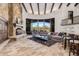 Spacious living room with a stone fireplace, wooden beams, and a view of the desert landscape at 7552 E Whisper Rock Trl, Scottsdale, AZ 85266