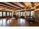 Spacious living room has wood floors, beamed ceilings, a fireplace, and double doors leading to a patio at 7552 E Whisper Rock Trl, Scottsdale, AZ 85266