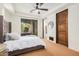 Bright bedroom with a ceiling fan and large window with exterior views at 7552 E Whisper Rock Trl, Scottsdale, AZ 85266