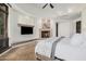 Elegant main bedroom featuring a fireplace, and large windows for natural light at 7552 E Whisper Rock Trl, Scottsdale, AZ 85266