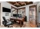 Features of a spacious home office, wood beam ceiling, and ample lighting for a productive workspace at 7552 E Whisper Rock Trl, Scottsdale, AZ 85266
