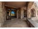 Covered patio with stone arches, views of the desert landscape, and outdoor access at 7552 E Whisper Rock Trl, Scottsdale, AZ 85266