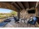 Outdoor patio seating area features stunning views, a built-in spa and a stone fireplace for relaxation at 7552 E Whisper Rock Trl, Scottsdale, AZ 85266