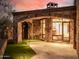 Exterior patio with stone arches, tile roof, and well maintained green space at 7552 E Whisper Rock Trl, Scottsdale, AZ 85266