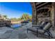 Stunning backyard pool with a stone waterfall feature and shaded lounge area at 7552 E Whisper Rock Trl, Scottsdale, AZ 85266
