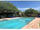 Large pool with clear blue water, surrounded by lounge chairs and lush landscaping, creating a relaxing environment at 7552 E Whisper Rock Trl, Scottsdale, AZ 85266