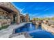 Inviting pool area with rock accents and a seamless transition to outdoor living spaces at 7552 E Whisper Rock Trl, Scottsdale, AZ 85266