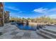 Beautiful swimming pool with a tiled deck and mature desert landscaping beyond at 7552 E Whisper Rock Trl, Scottsdale, AZ 85266