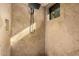 Modern shower stall with large shower head and natural light from a window at 7552 E Whisper Rock Trl, Scottsdale, AZ 85266