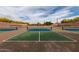 Multiple tennis courts with new nets are surrounded by desert landscaping at 7552 E Whisper Rock Trl, Scottsdale, AZ 85266