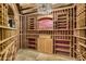 A custom wine cellar with wooden racks and a decorative chandelier at 7552 E Whisper Rock Trl, Scottsdale, AZ 85266