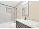 Bathroom featuring a shower with stylish tile and a vanity with a marble countertop at 7607 N 42Nd Ln, Phoenix, AZ 85051
