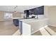 Open-concept kitchen with blue cabinets, stainless steel appliances, and a generous island, perfect for entertaining guests at 7607 N 42Nd Ln, Phoenix, AZ 85051