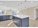 Well-lit kitchen showcasing blue cabinets, stainless steel appliances, and a functional island with plenty of counter space at 7607 N 42Nd Ln, Phoenix, AZ 85051