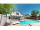 Spacious backyard featuring a refreshing pool, covered patio, and block fence for privacy at 8541 W Pershing Ave, Peoria, AZ 85381