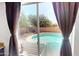 View of the backyard and pool through sliding glass doors at 8541 W Pershing Ave, Peoria, AZ 85381